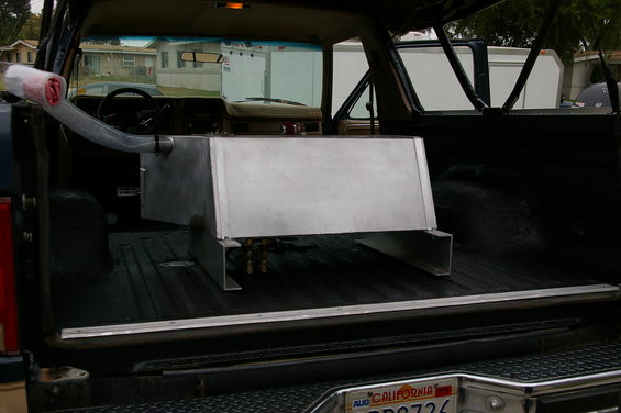 Interior of a 1986 Ford Bronco with a large auxiliary fuel tank installed