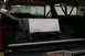 1986 Ford Bronco - The interior of a 1986 Ford Bronco shows a large custom metal tank mounted in the cargo area, likely for auxiliary fuel.