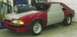 1990 Ford Mustang - A red and silver 1990 Ford Mustang is shown in a garage with a large air intake scoop and unfinished body panels.