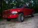 1998 Dodge 1500 - This red 1998 Dodge 1500 pickup truck is shown from the front 3/4 angle, parked outdoors.
