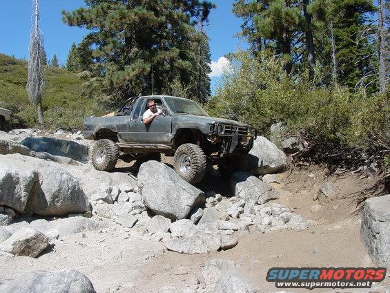 Gray off-road truck navigating rocky terrain