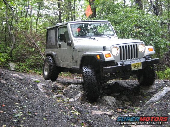 Silver 2002 Jeep Wrangler on rocky trail