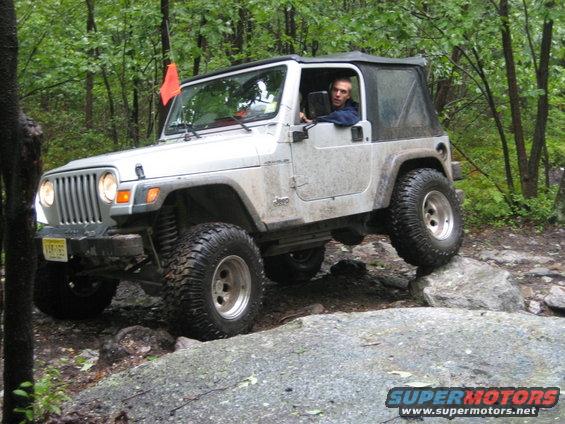 Silver 2002 Jeep Wrangler navigating rocks off-road