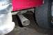 1995 Ford Bronco - Close-up view of the exhaust pipe and rear bumper of a red vehicle.