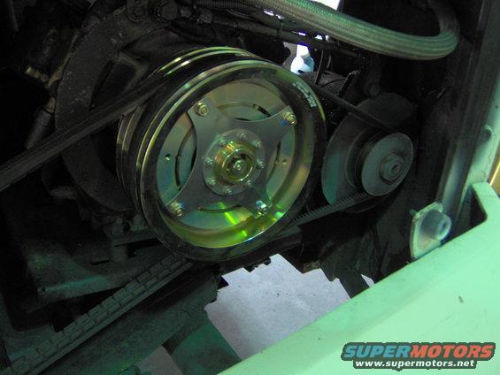 Engine pulley system with a shiny, multi-groove pulley and belts
