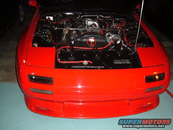 Red car engine bay with "nopistons.com" visible