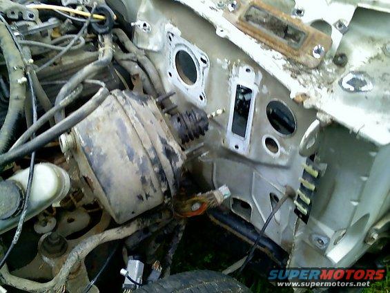 Engine bay firewall with brake booster, master cylinder, and wiring harness visible