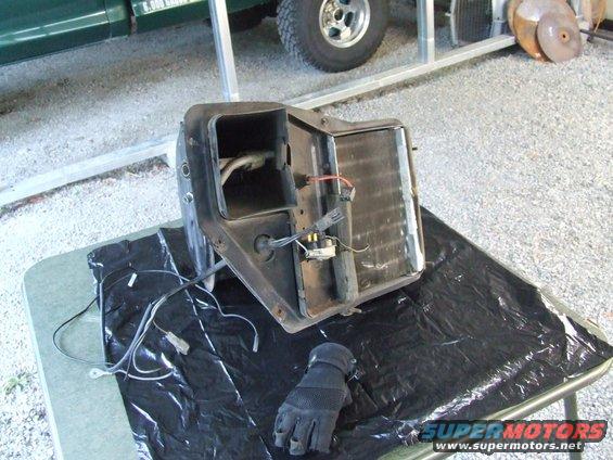 car heater core assembly with wires and a glove on a table