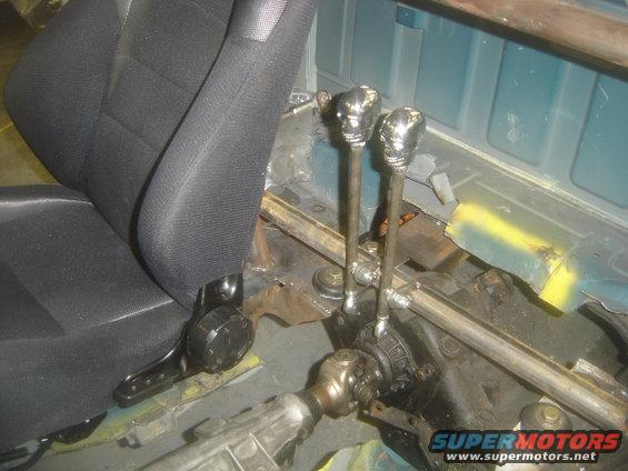 Close-up of custom skull shifter knobs and transmission tunnel in a vehicle