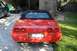 1994 Chevrolet Corvette - Rear view of a red 1994 Chevrolet Corvette convertible parked in a driveway.