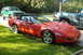 1994 Chevrolet Corvette - Red 1994 Chevrolet Corvette convertible with black top, parked outdoors near other vehicles.