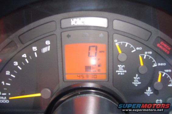 Car dashboard with tachometer, speedometer, oil pressure, oil temp, and water temp gauges. Digital odometer shows 45310