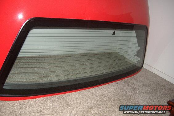 Red rear hatch with tinted rear window and defroster lines