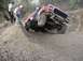 1979 Ford Bronco - This modified 1979 Ford Bronco is shown tackling a challenging off-road obstacle with two onlookers.