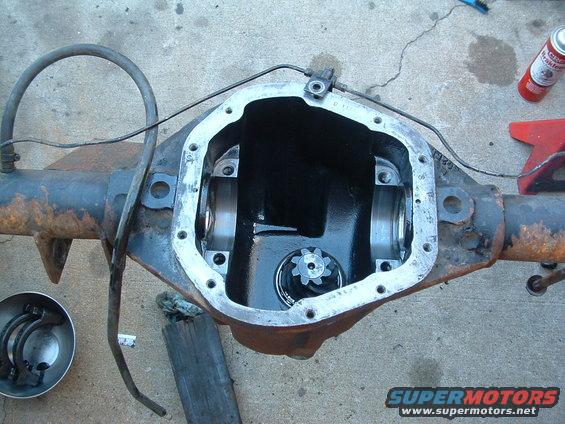Differential housing with cover removed, showing internal gears and brake line