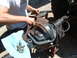 1994 Jeep YJ - Mechanic removes differential cover, with bolts laid out on a blue cloth.