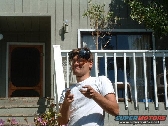 Man wearing goggles and glasses, pointing forward