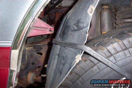 dcp_0540.jpg Inner fender peel back with a bungi cord, made life easier removing flange nuts!
