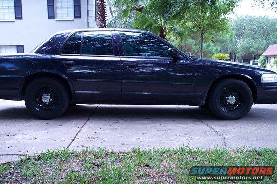 Dark sedan with black steel wheels parked on a concrete driveway