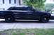 1999 Ford Crown Victoria - Side view of a dark sedan with black steel wheels.