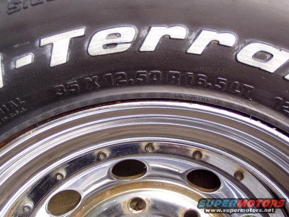 Close-up of a BFGoodrich All-Terrain T/A tire with size 35x12.50R16.5 LT and a chrome rim