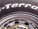 1989 Ford F-250 - A close-up view of a BFGoodrich All-Terrain T/A tire mounted on a chrome wheel.