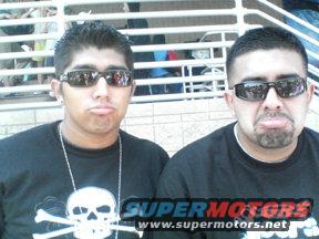 Two men making faces, wearing sunglasses. "SUPERMOTORS www.supermotors.net" text visible