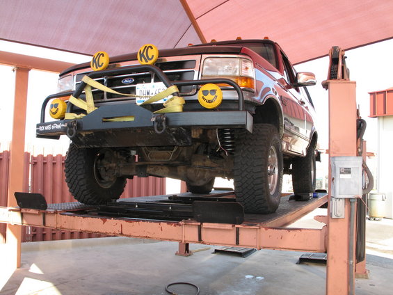 1995 Ford Bronco front view on lift with KC lights and custom bumper