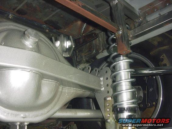 Rear axle assembly with silver-painted differential housing and adjustable coilover shock absorber