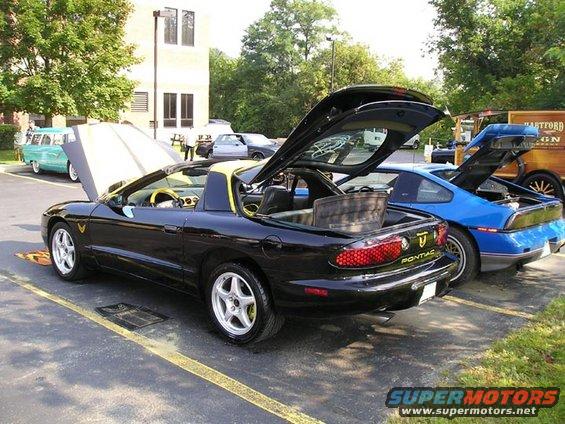 Black 1994 Pontiac Trans Am convertible rear view with yellow trim and interior