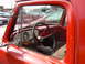 1966 Ford F-250 - Interior view of a 1966 Ford F-250 pickup truck, with other vehicles parked outside.