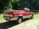 1990 Chevrolet C/K Pickup - Red 1990 Chevrolet C/K pickup truck, Z71 model, loaded with lumber in the bed.