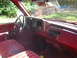 1990 Chevrolet C/K Pickup - The interior of a red truck is shown, the dashboard, steering wheel, and seats.