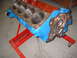 1969 Ford Mustang - A painted engine block is mounted on a red stand, ready for assembly or inspection.