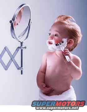baby with shaving cream on face, holding razor