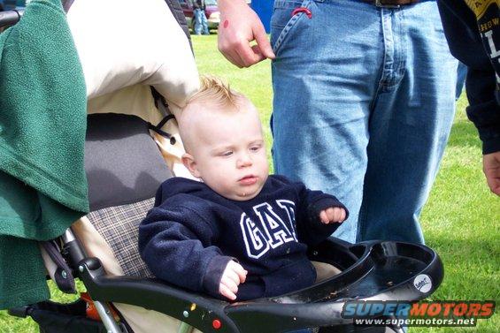 Baby in stroller with mohawk and GAP sweatshirt