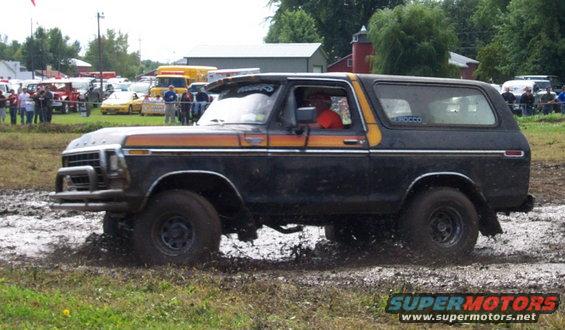 Black and orange 1979 Ford Bronco in mud