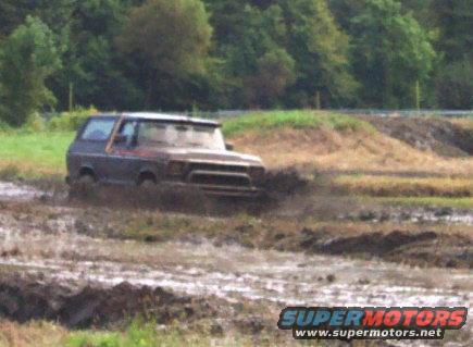 Ford Bronco stuck in mud, front grille partially submerged