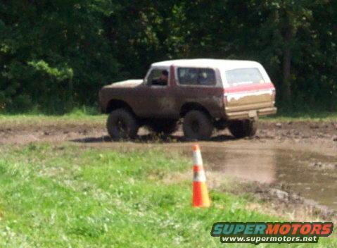 1979 Ford Bronco in mud, rear quarter view, brown and white