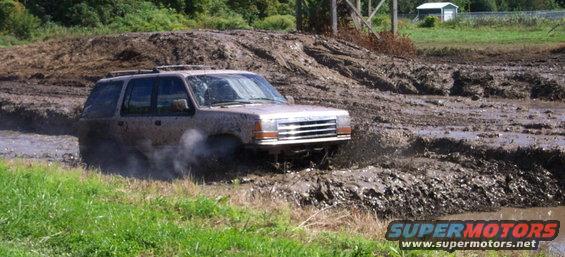 Brown Ford Explorer navigating a mud pit