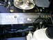2003 Mercury Marauder - Close-up of an engine bay, focusing on a silver component inscribed with "POWERED BY".