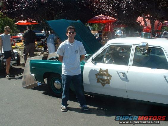 Green and white 1967 Plymouth Fury I King County Sheriff car, side view, with hood open