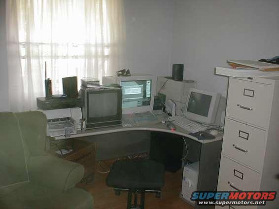 Office scene with computers, filing cabinet, and chair