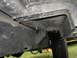 1977 Jeep Wagoneer - Undercarriage view of a vehicle, focusing on the frame and tire. Supermotors.net logo is present.