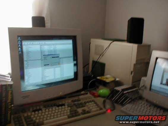 Computer monitor displaying a spreadsheet, keyboard, mouse, and tower on a desk