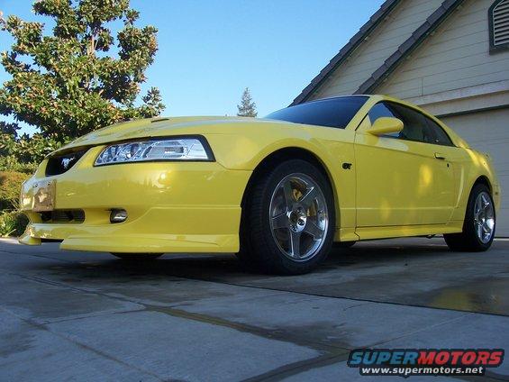 Yellow 2002 Ford Mustang parked in a driveway