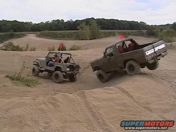 Jeep CJ-series and a Ford Bronco off-roading on sand dunes