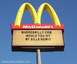 1978 Ford Mustang II - A McDonald's sign displays a message board with text and website addresses against a blue sky.