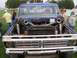 1994 Ford F-150 - This heavily modified blue pickup truck features a prominent Ford grille and an exposed engine bay with twin turbochargers.