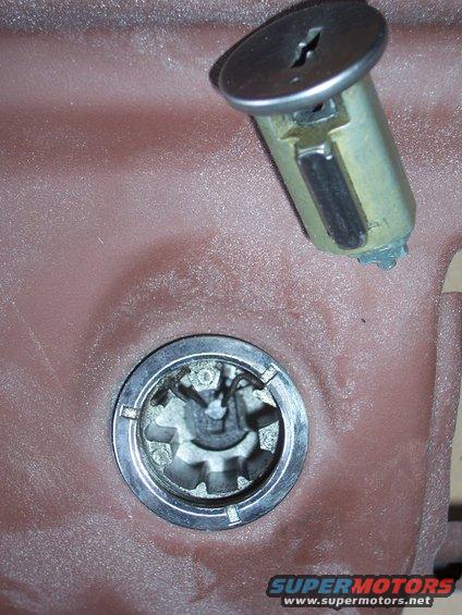 Door lock cylinder removed from its housing, showing internal mechanism